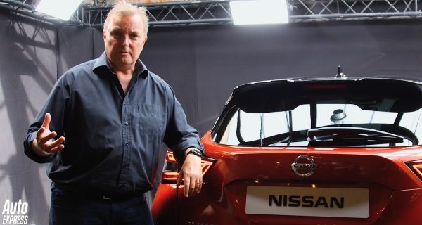 The electric nissan leaf driving down a green country road