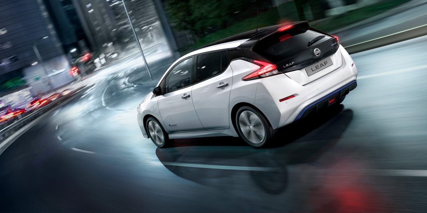 Nissan LEAF driving on a city street at night