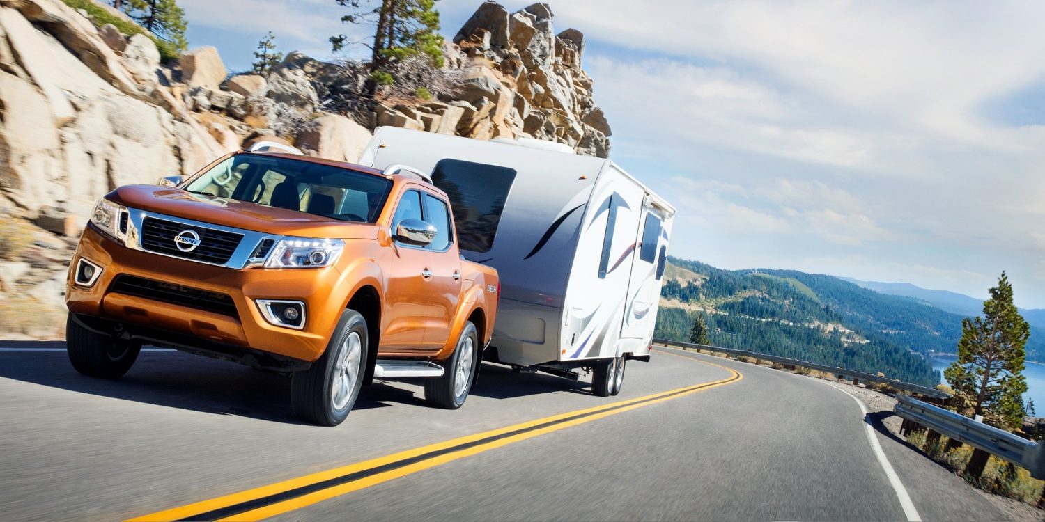 Nissan Navara hauling trailer up mountain road