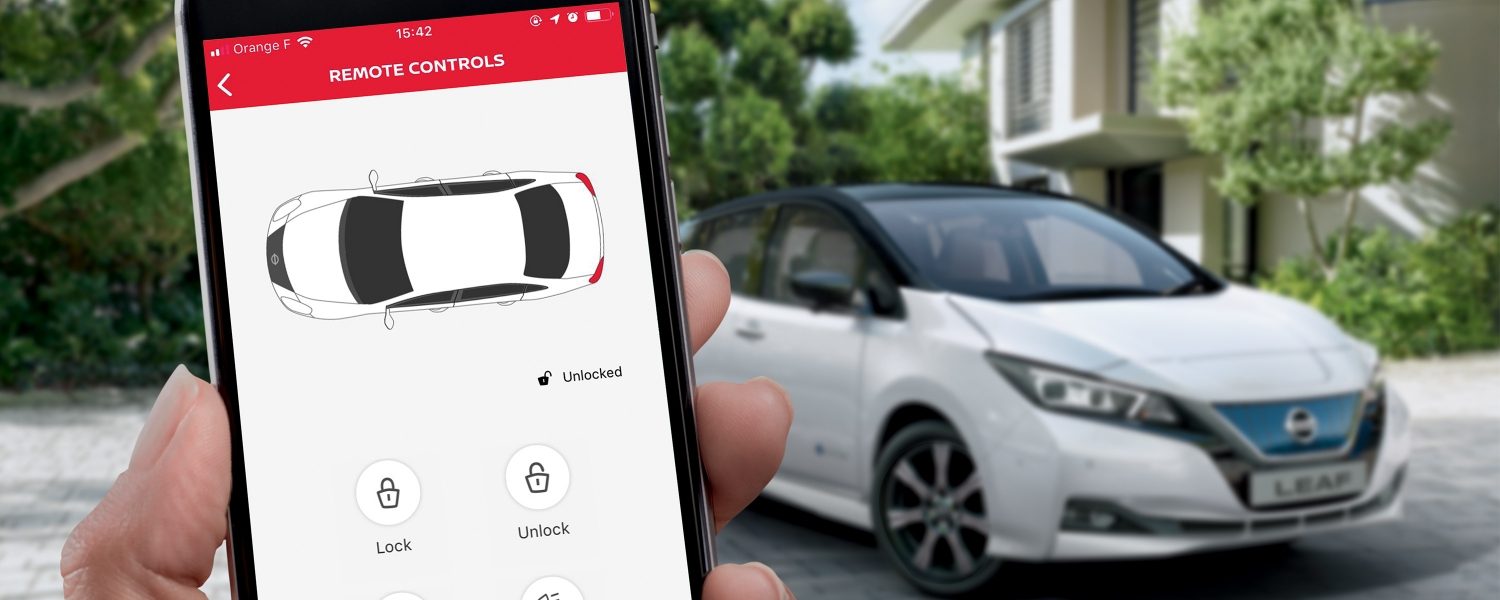 Smartphone with LEAF screen and Nissan LEAF in the background