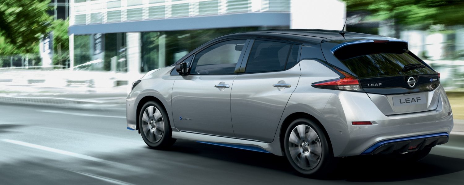 Nissan LEAF driving in the city rear angle
