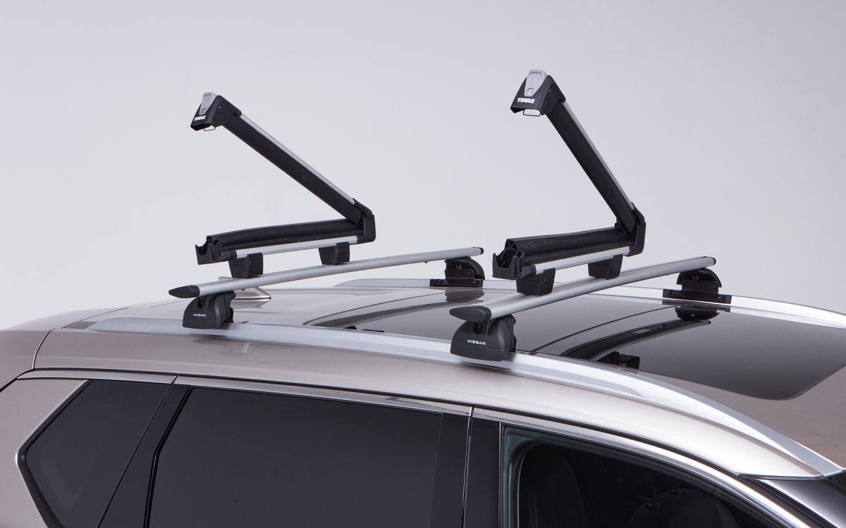 Geöffnete Skiträger auf dem Dach eines Nissan X-Trail montiert.