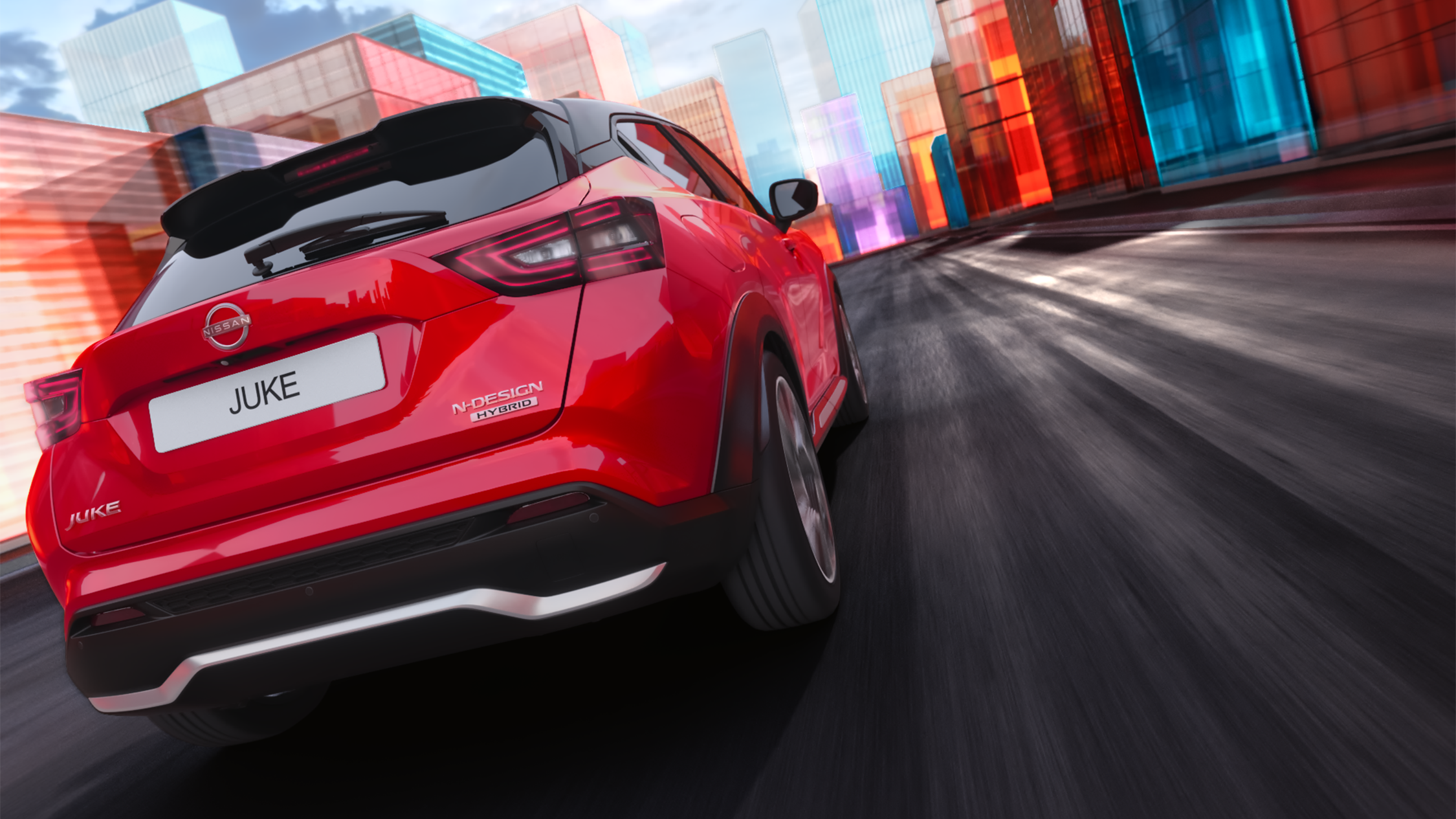 Vista trasera 3/4 del Nissan JUKE circulando por una carretera