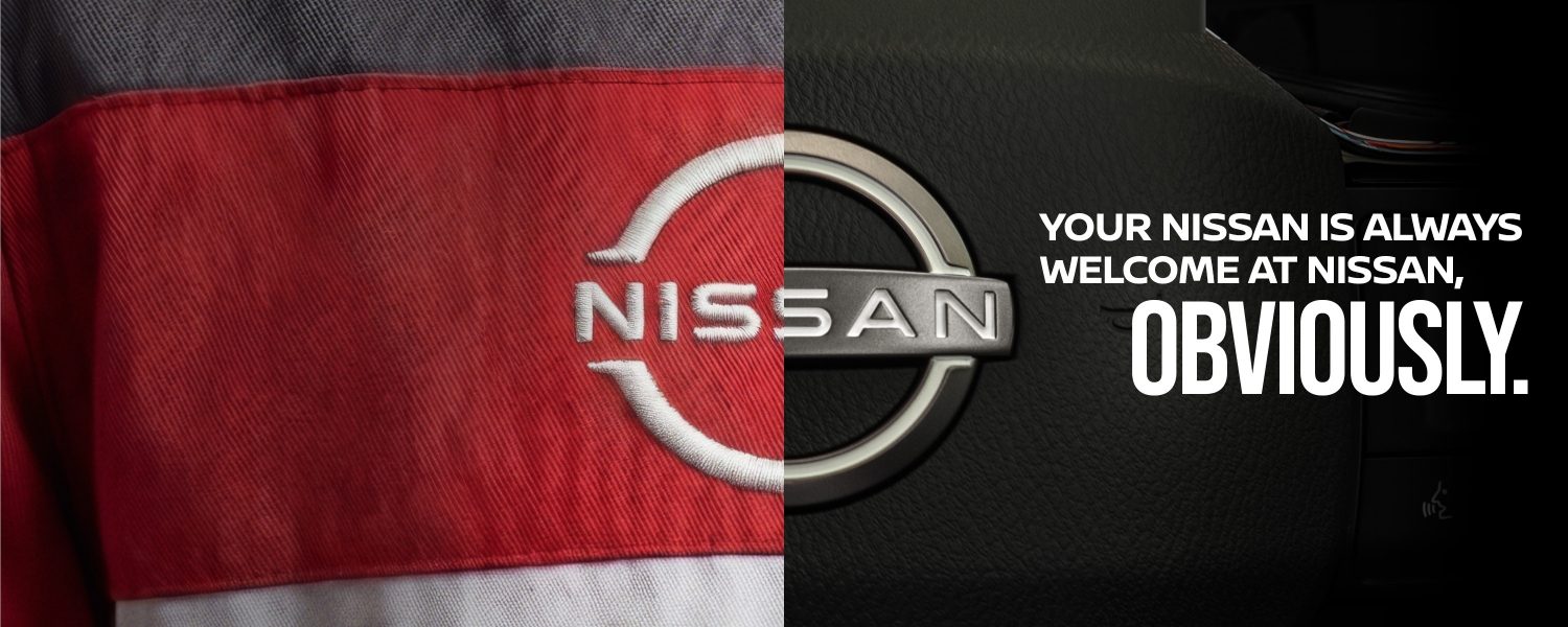 Family walks on grass next to a Nissan Qashqai