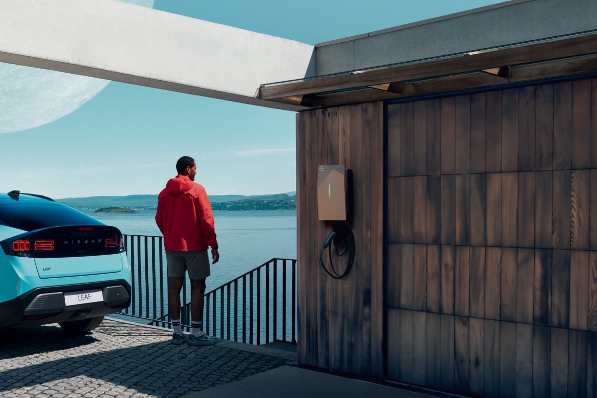 Nissan EV parked at a home charge point at dusk