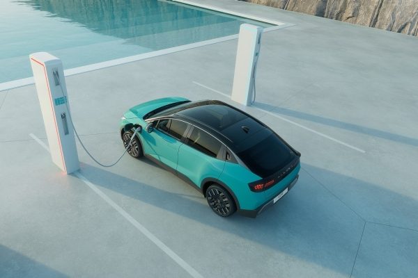 Person exiting or approaching an electric vehicle in a business context