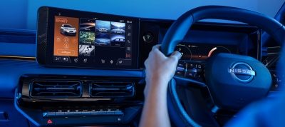 A couple smile putting their seatbelt on