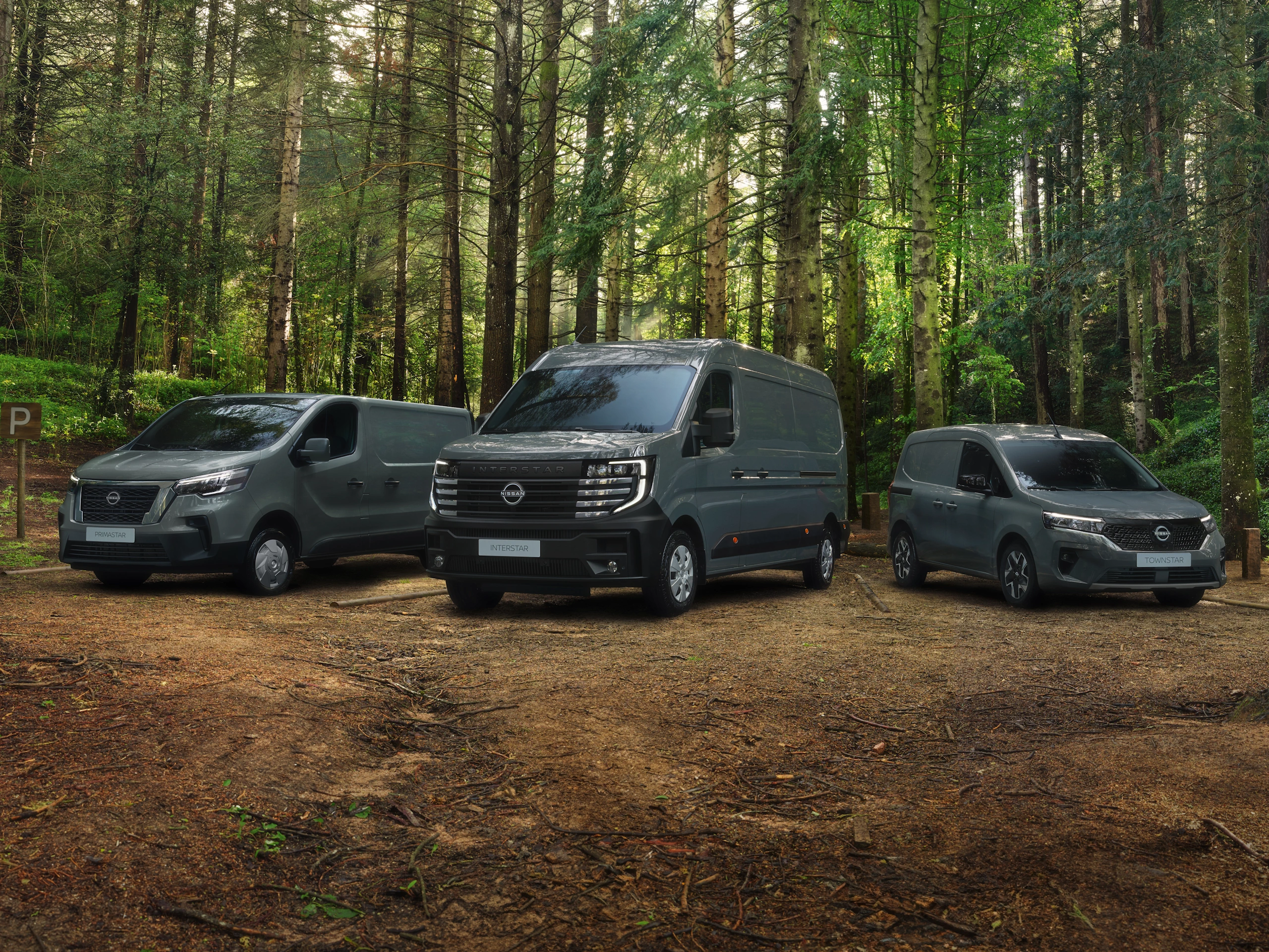 Grey Nissan Townstar, Primastar and Interstar parked in a forest