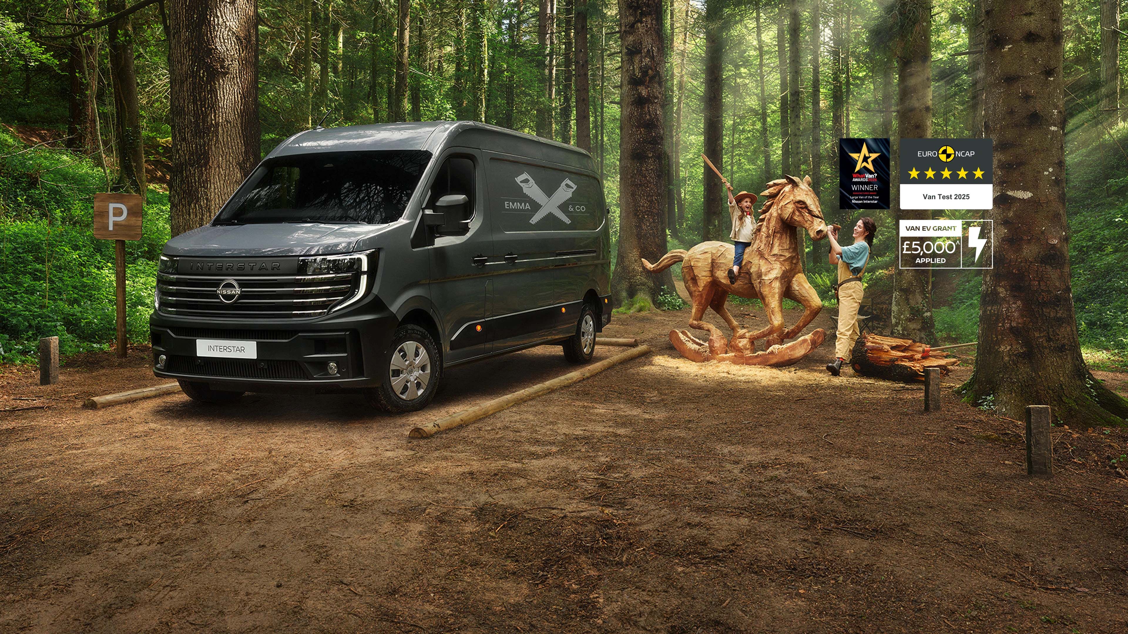 Nissan Interstar 3/4 front parked van in the woods with family playing around a wooden horse