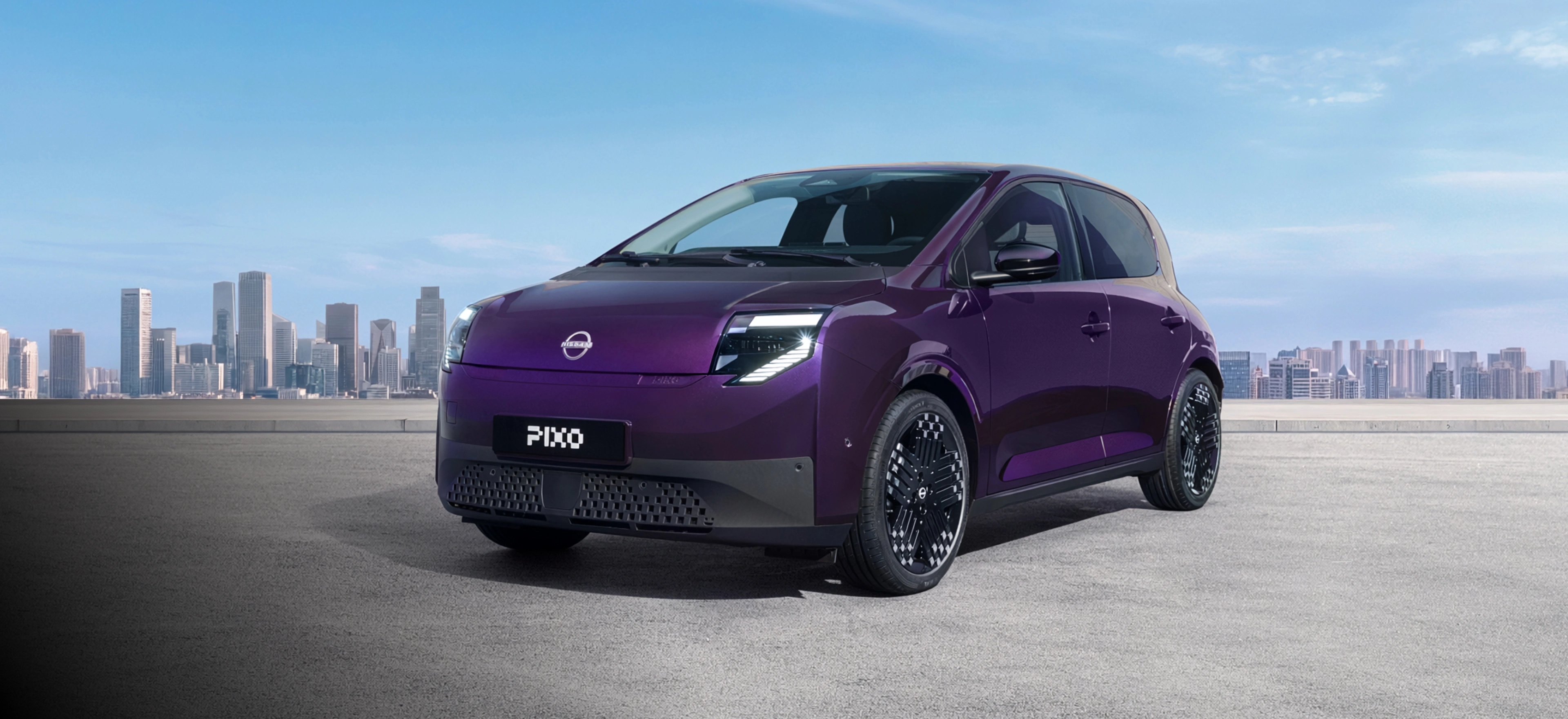 New Nissan PIXO overlooking a city in the background
