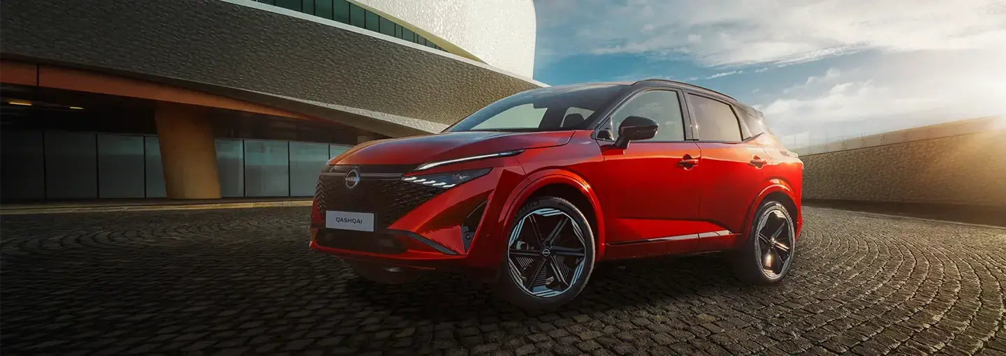 Nissan Ariya 100% electric driving on a red a blue background