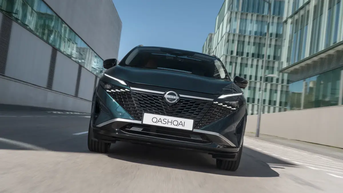 A teal nissan Qashqai driving towards you