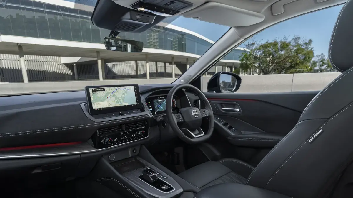 Nissan Qashqai interior, showing the driver side seat and infotainment systems