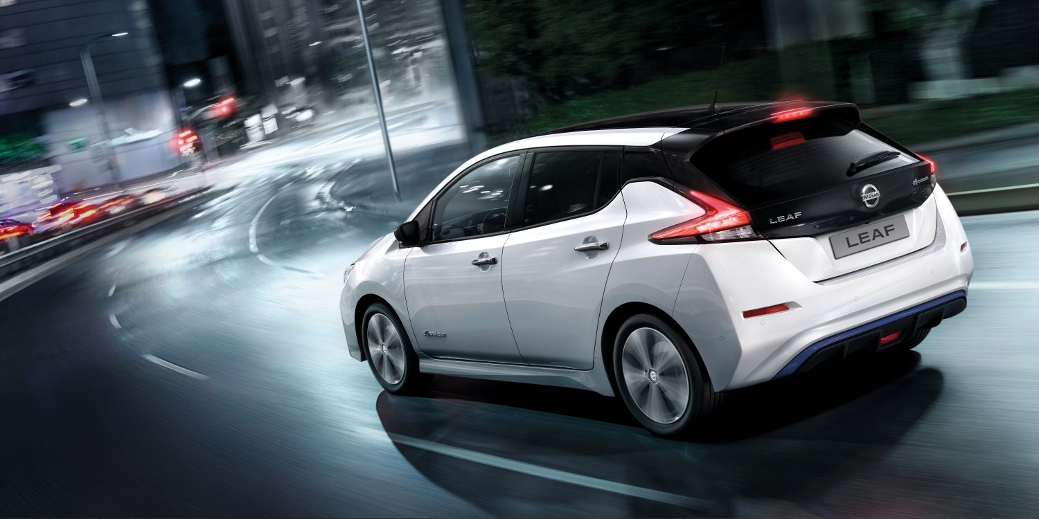 Nissan LEAF driving on a city street at night