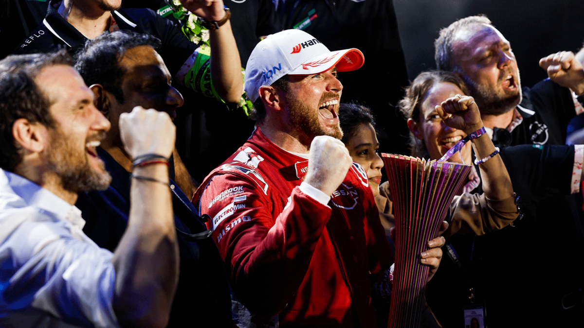 Oliver Rowland celebrating his victory, holding up the trophy.