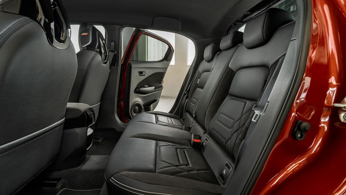 Nissan Juke interior front seats side view towards back with passenger