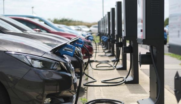 Nissan LEAF, kas pieslēgti pie elektroauto uzlādes stacijas.