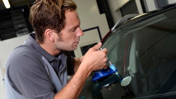 Nissan technician repairing crack in windscreen