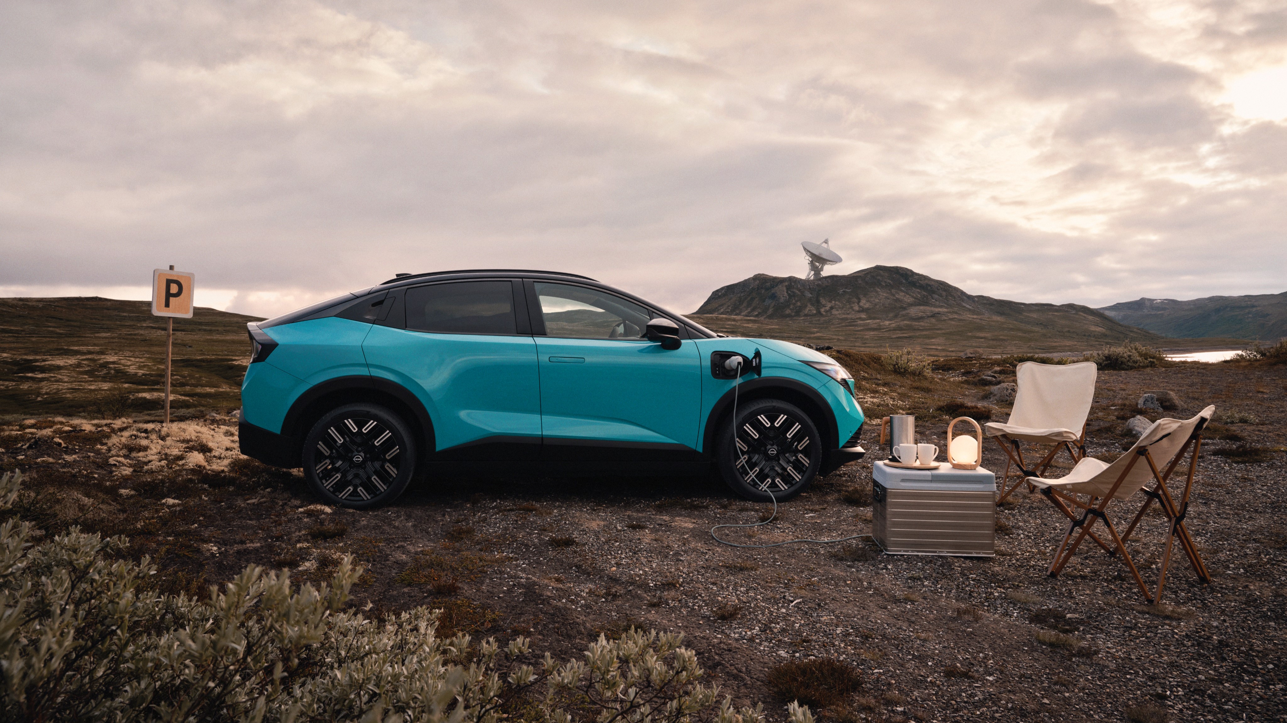 Nissan Leaf electric family car side view with driver