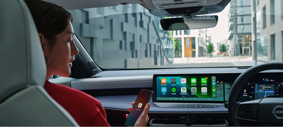 Driver inside Nissan Leaf adjusting settings