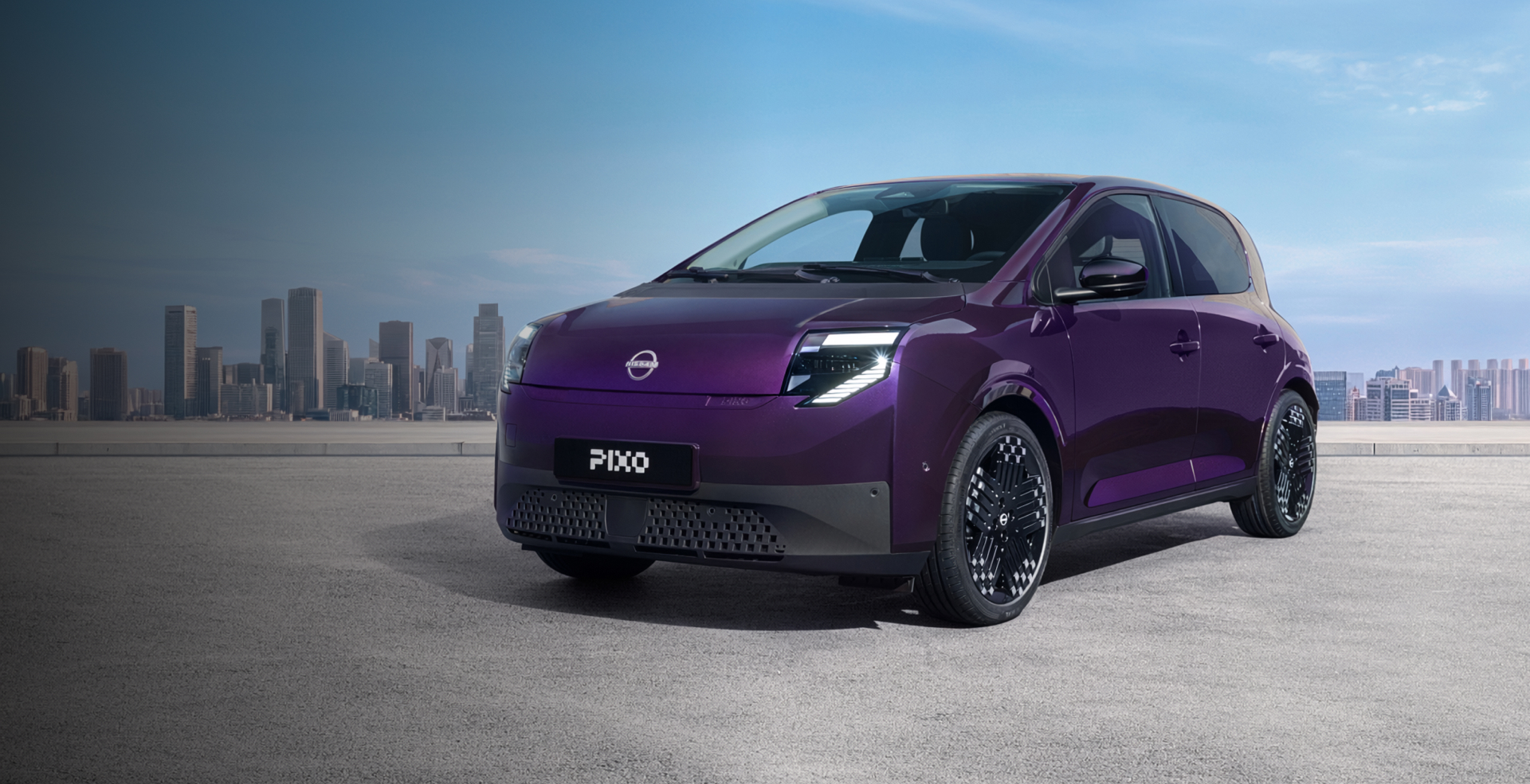 New Nissan PIXO overlooking a city in the background