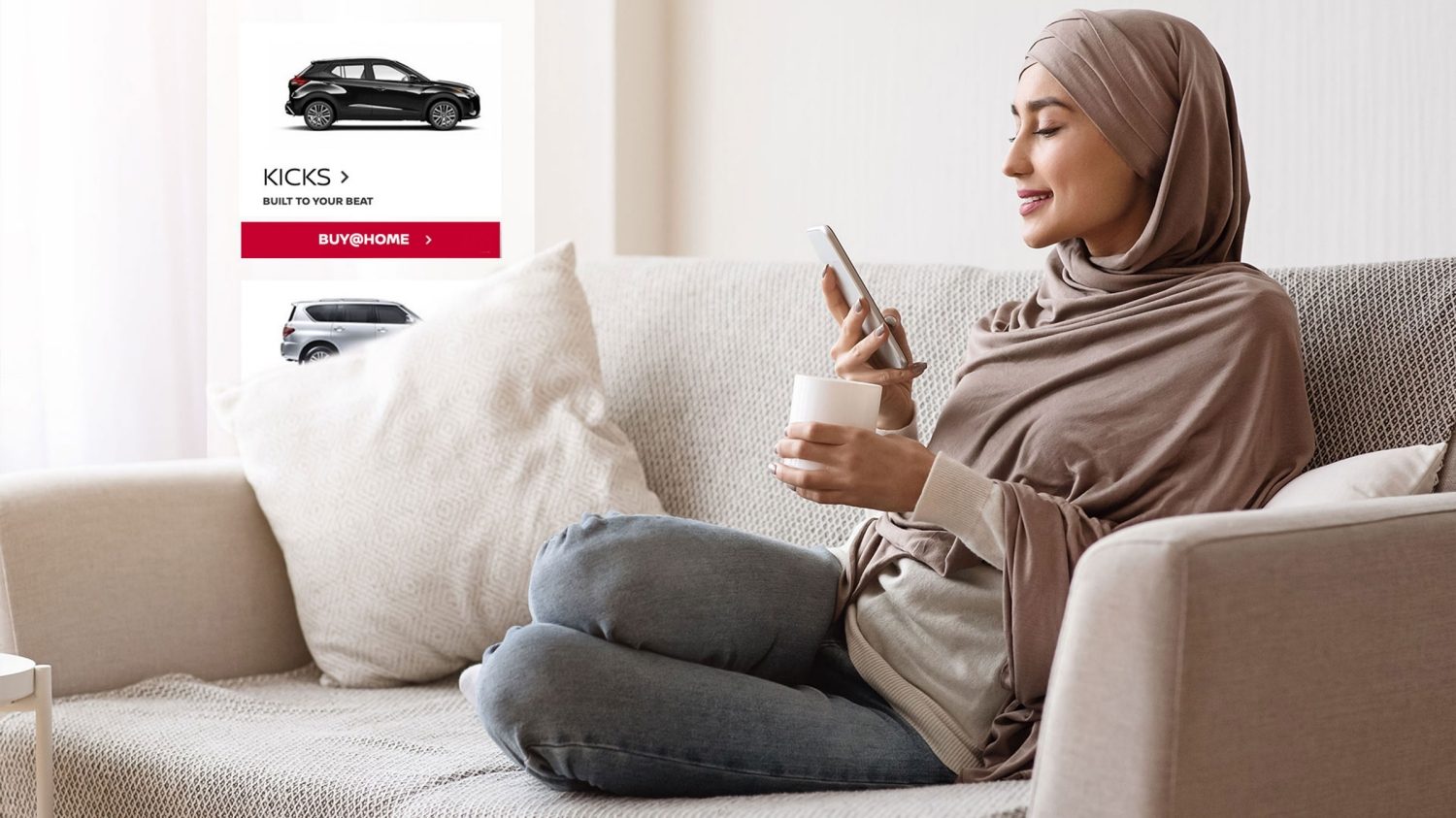 Woman navigating NISSAN site on a couch