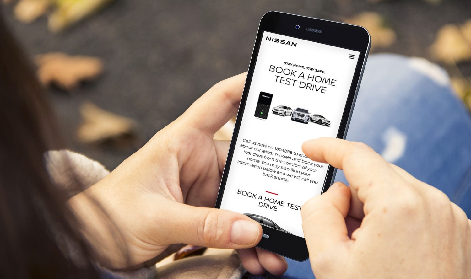 Woman navigating NISSAN site at home