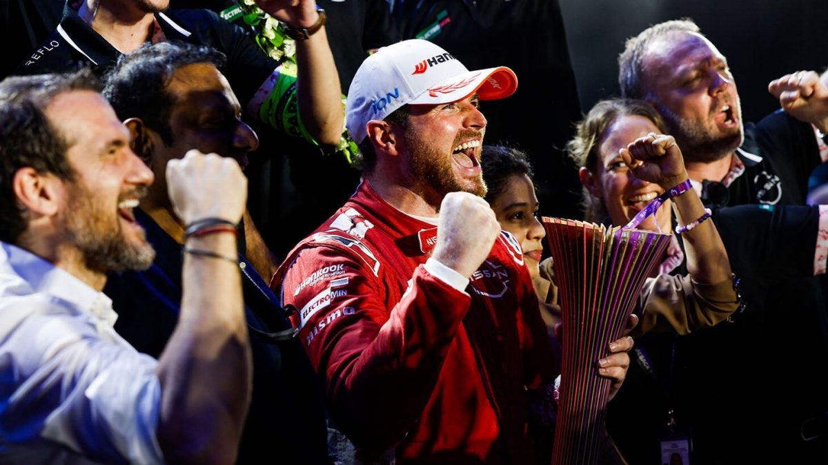 Oliver Rowland celebrating his victory, holding up the trophy.