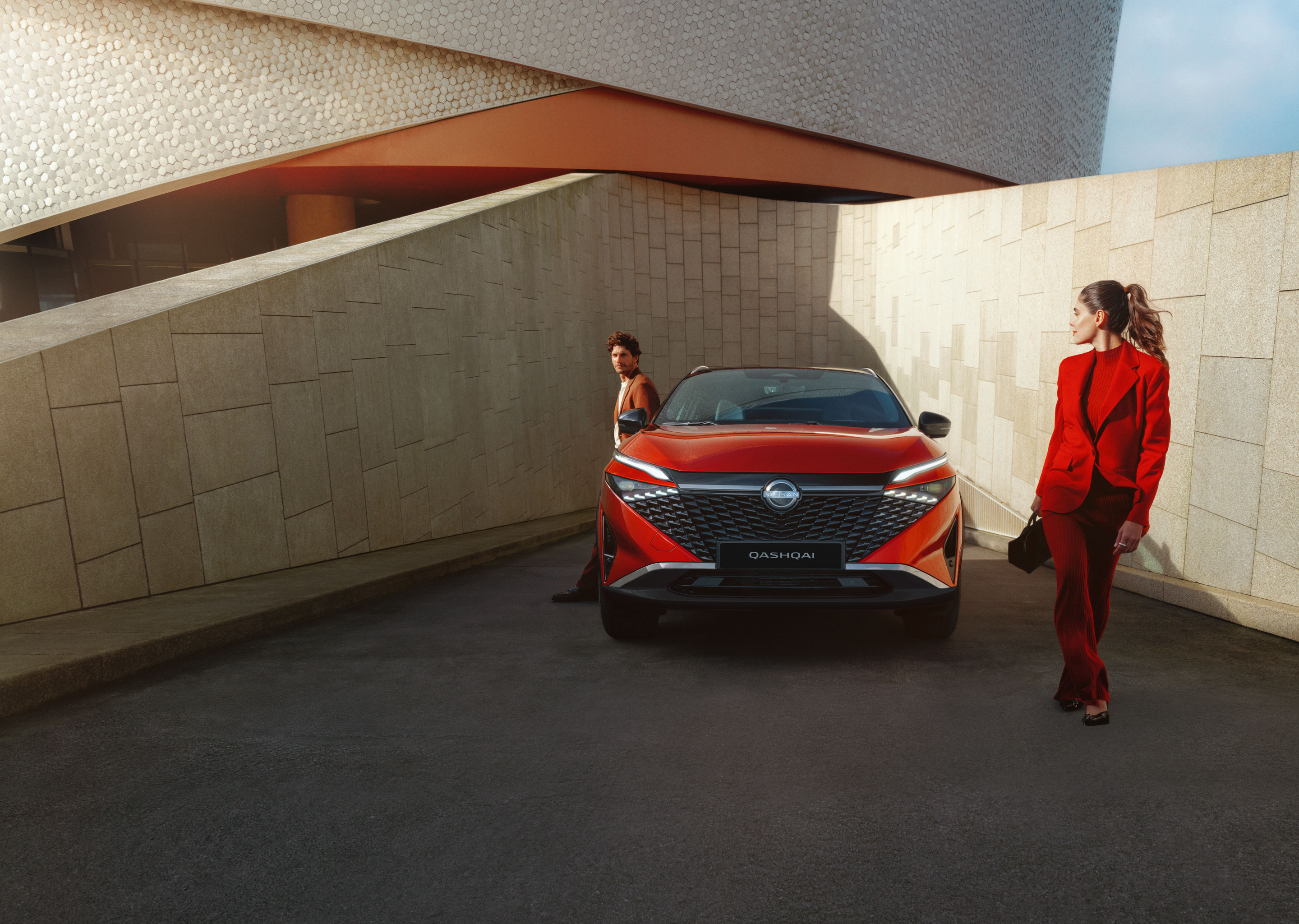 Nissan Qashqai e-Power full front static view with man leaning against the bonnet.